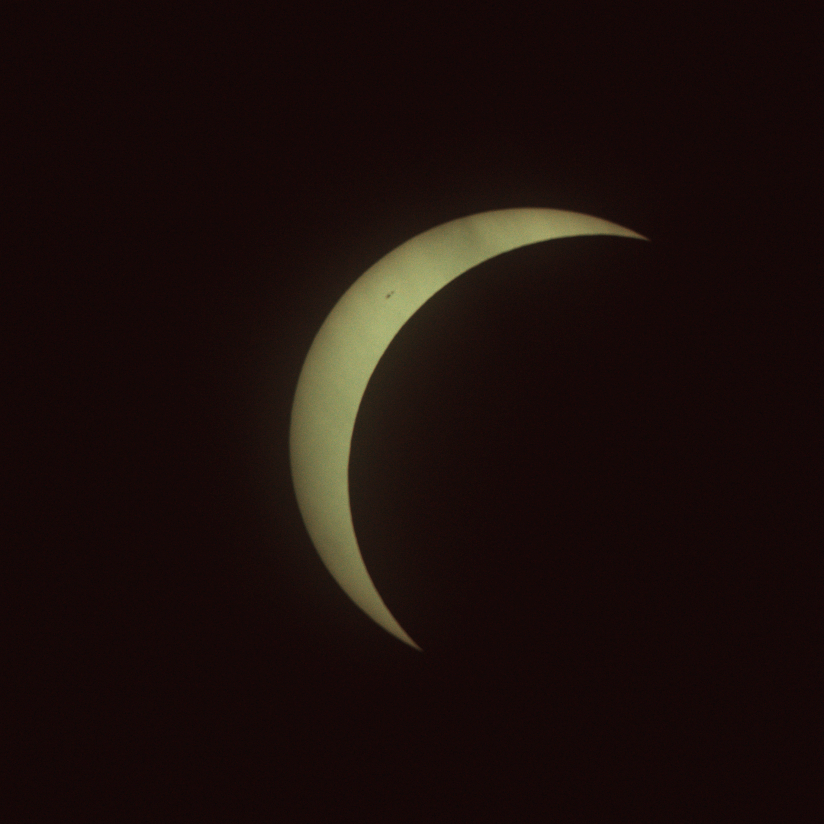 The sun with mostly blocked by the moon, leaving a thin crescent in the top left