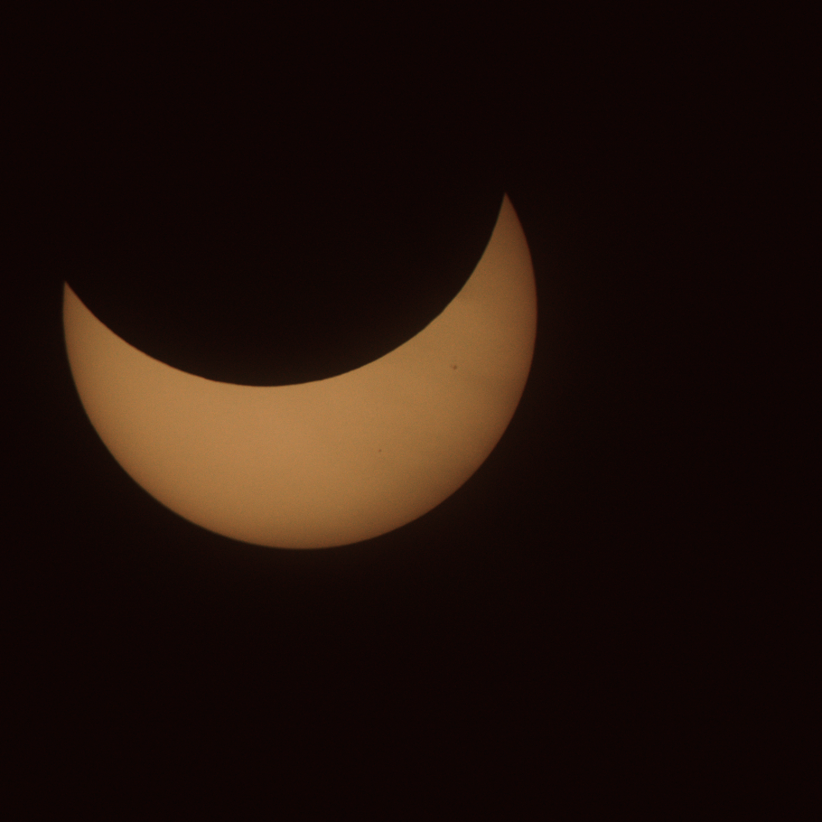 The sun with a bit less than half blocked by the moon, leaving a 'U'-shaped crescent
